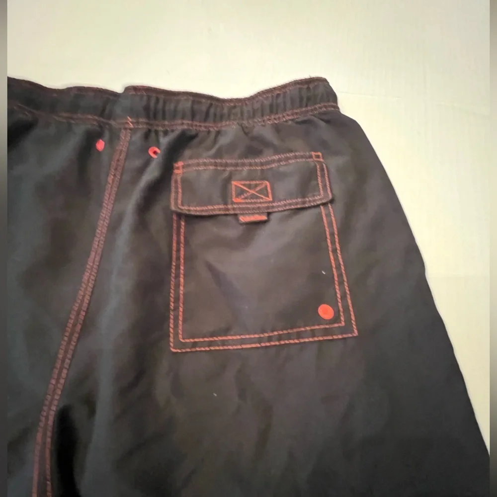 CALVIN KLEIN MENS SWIM TRUNKS. SIZE MEDIUM. BLACK WITH ORANGE STITCHING